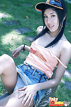 Yoko seated on bench strap falling from shoulder skirt riding up exposing her panties